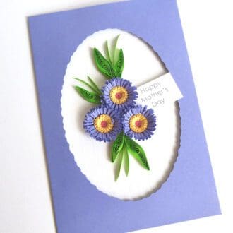 Handmade Mother's Day card with a trio of quilled flowers in lilac with an oval frame.