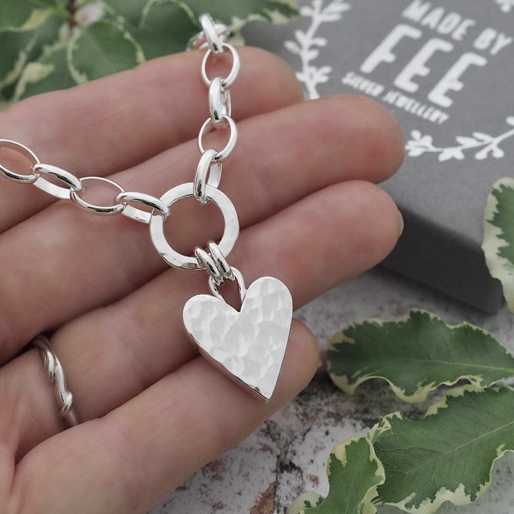 17mm wide chunky solid silver hammered heart pendant necklace suspended by a double jump ring bail from a 12mm diameter hammered silver circle on a large silver oval belcher chain.
