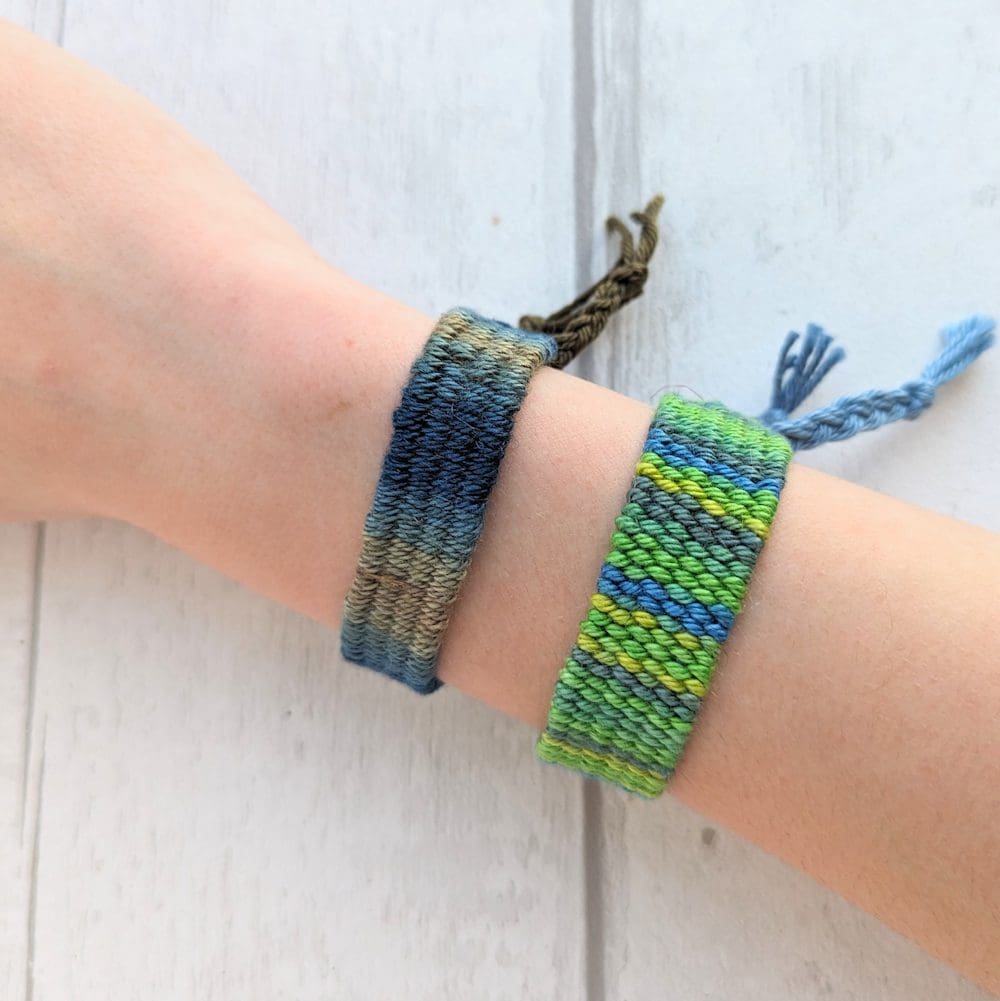 woven green bracelets on an arm