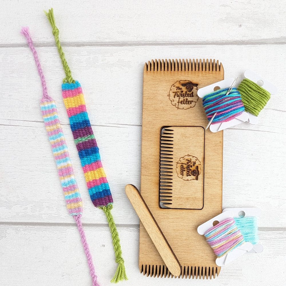 wooden weaving loom with coloured threads and woven bracelets