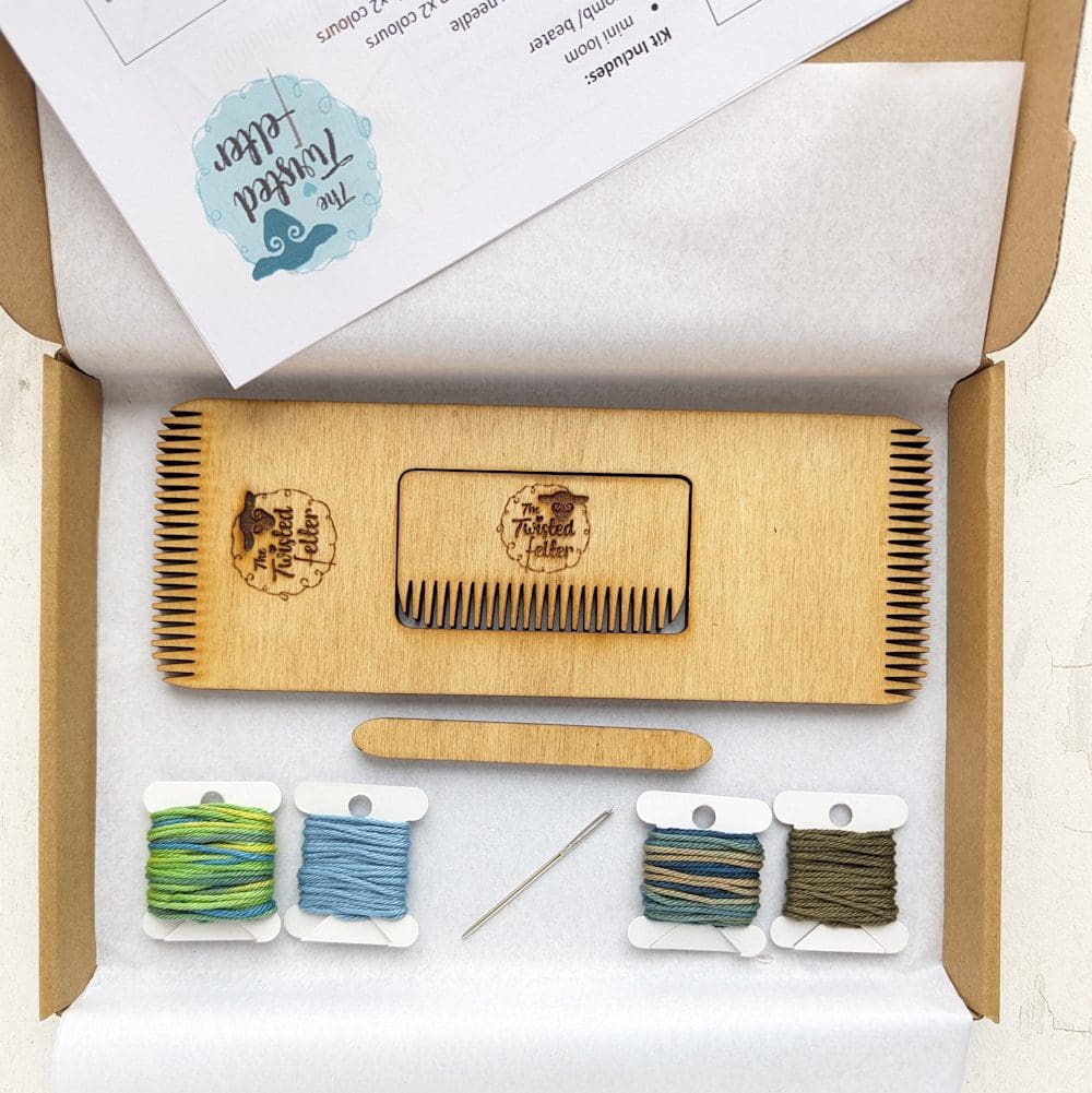 box containing a woven bracelet weaving kit