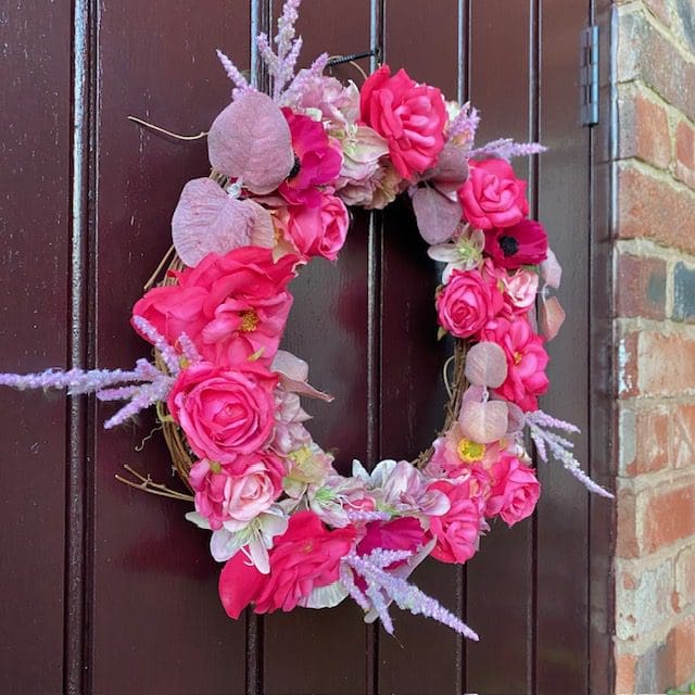 Bright pink front door wreath