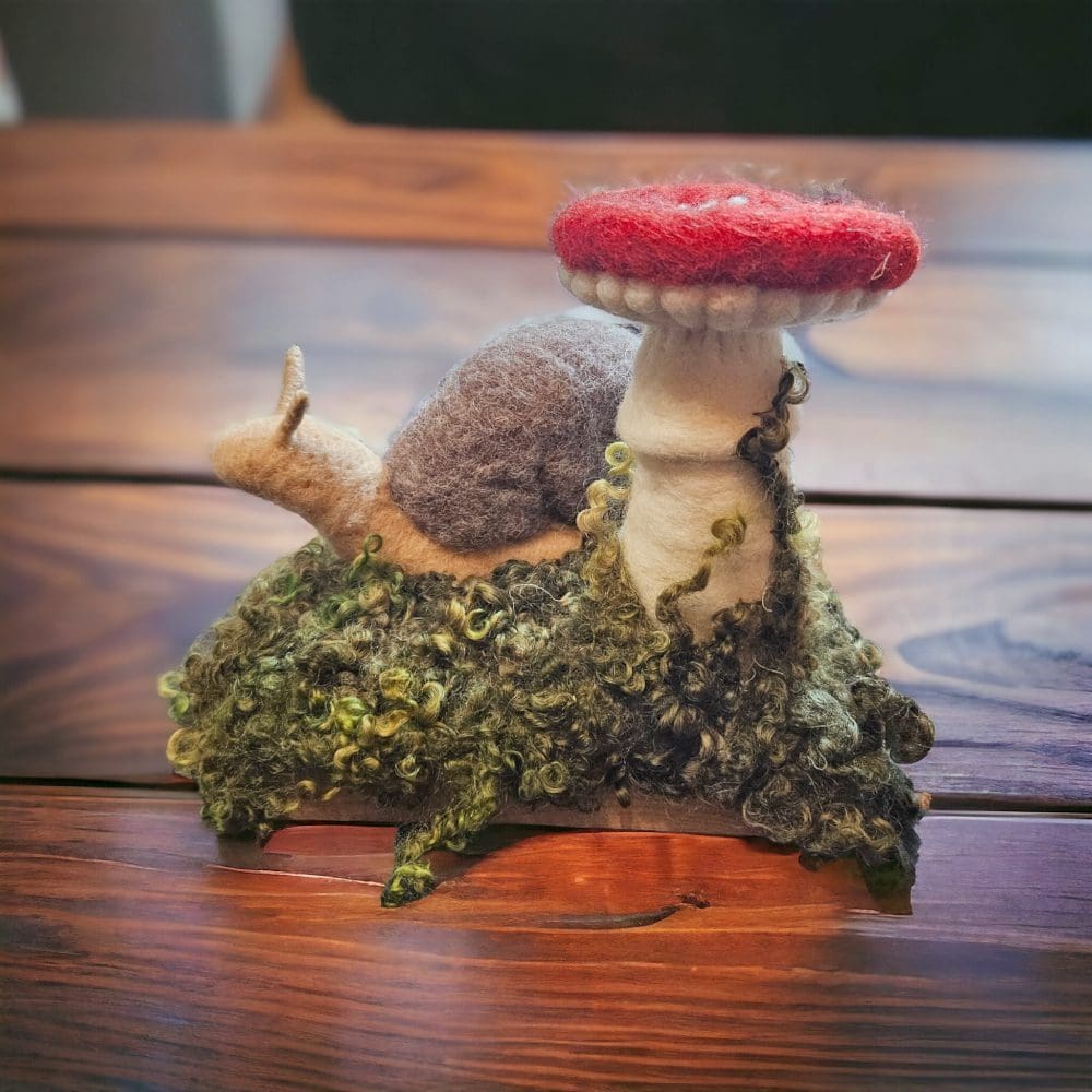 Back view of needle felted snail with toadstool