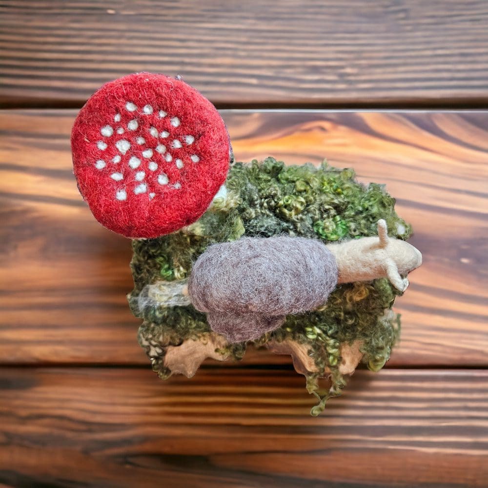 Top view of needle felted snail with toadstool