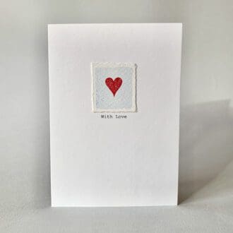 Hand painted Valentine's Day card with red embossed heart on a pale blue watercolour background with the words "With Love".