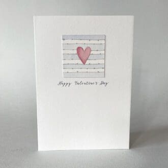 This A6 card has a beautiful hand painted red heart on a striped watercolour background. On the edge of each stripe is a silver line with little dots. Underneath it says 'Happy Valentine's Day'