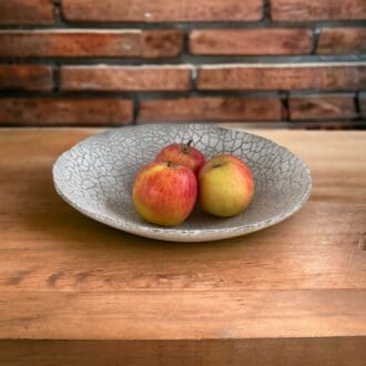 silver grey glass fruit bowl with apples