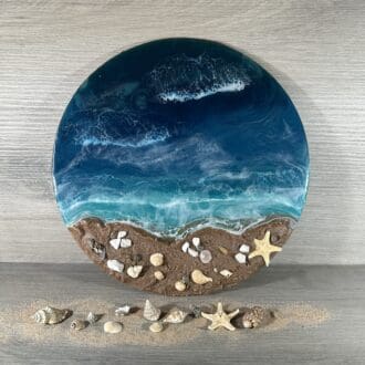 a 30cm round resin seascape with sand and shells