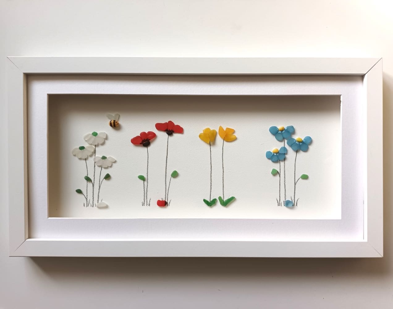 sea glass spring flowers in long frame forget me nots, daisies, daffodils and poppies