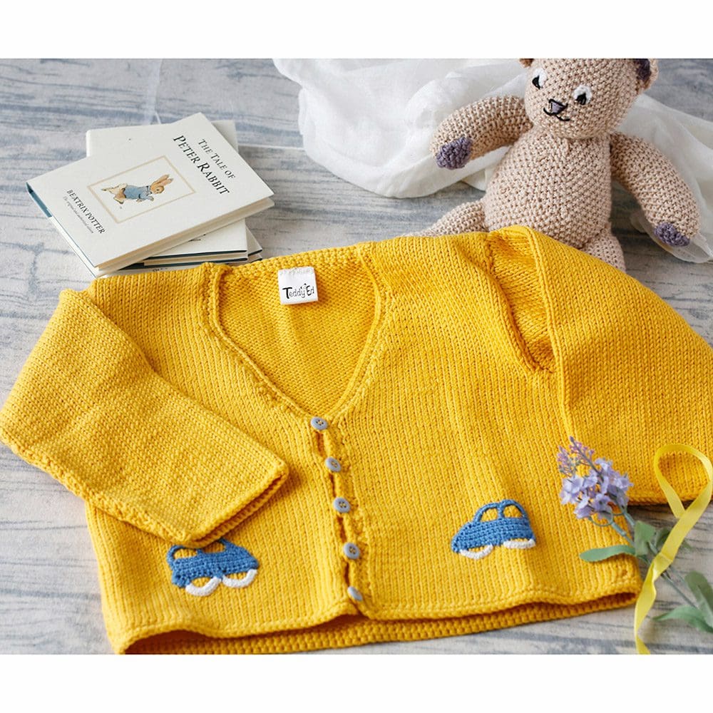 yellow hand knitted jacket for toddler with blue car motif decoration