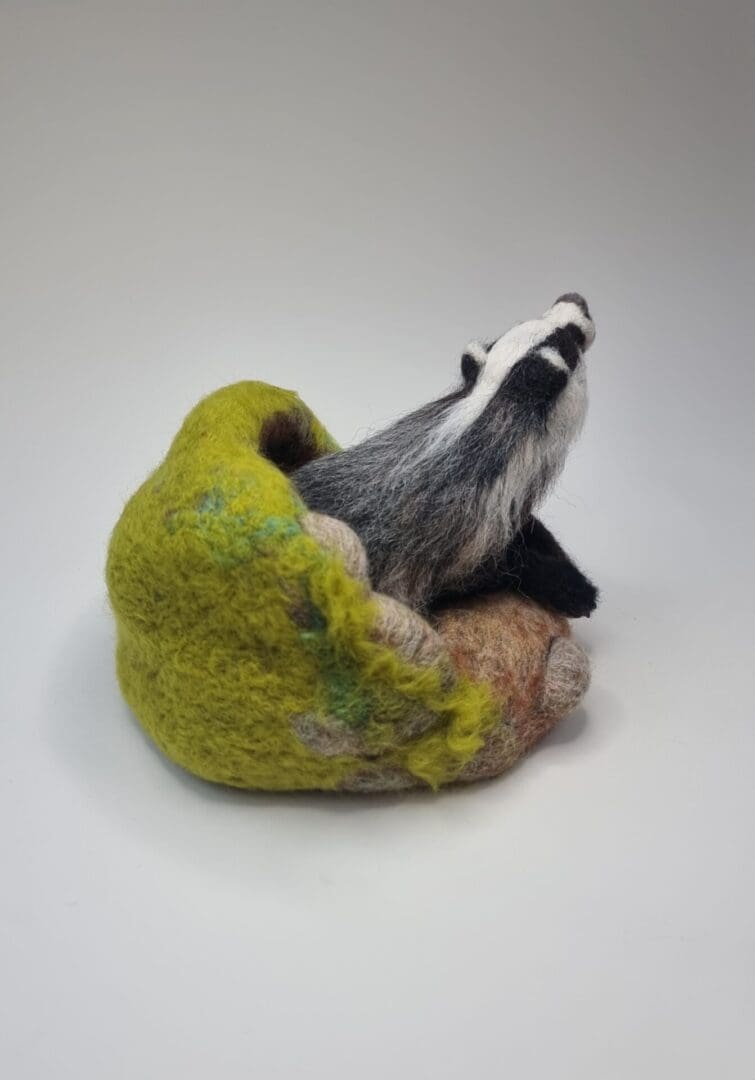 Needle felted Badger sculpture emerging from sett by Davina Brien- Two Little Hares Designs