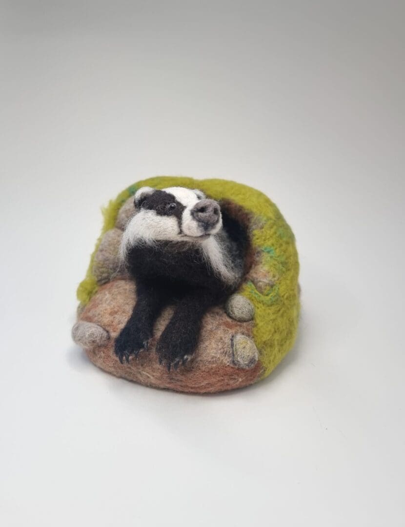 Needle felted Badger sculpture emerging from sett by Davina Brien- Two Little Hares Designs