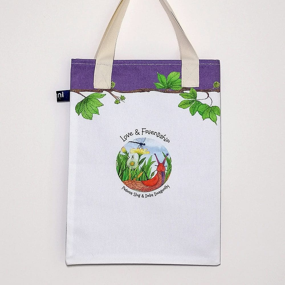 Back of the slug and dragonfly bookbag showing a 'Love and Friendship' logo on reverse. Purple trim on top with chestnut tree branch decoration and pale cream cotton handles