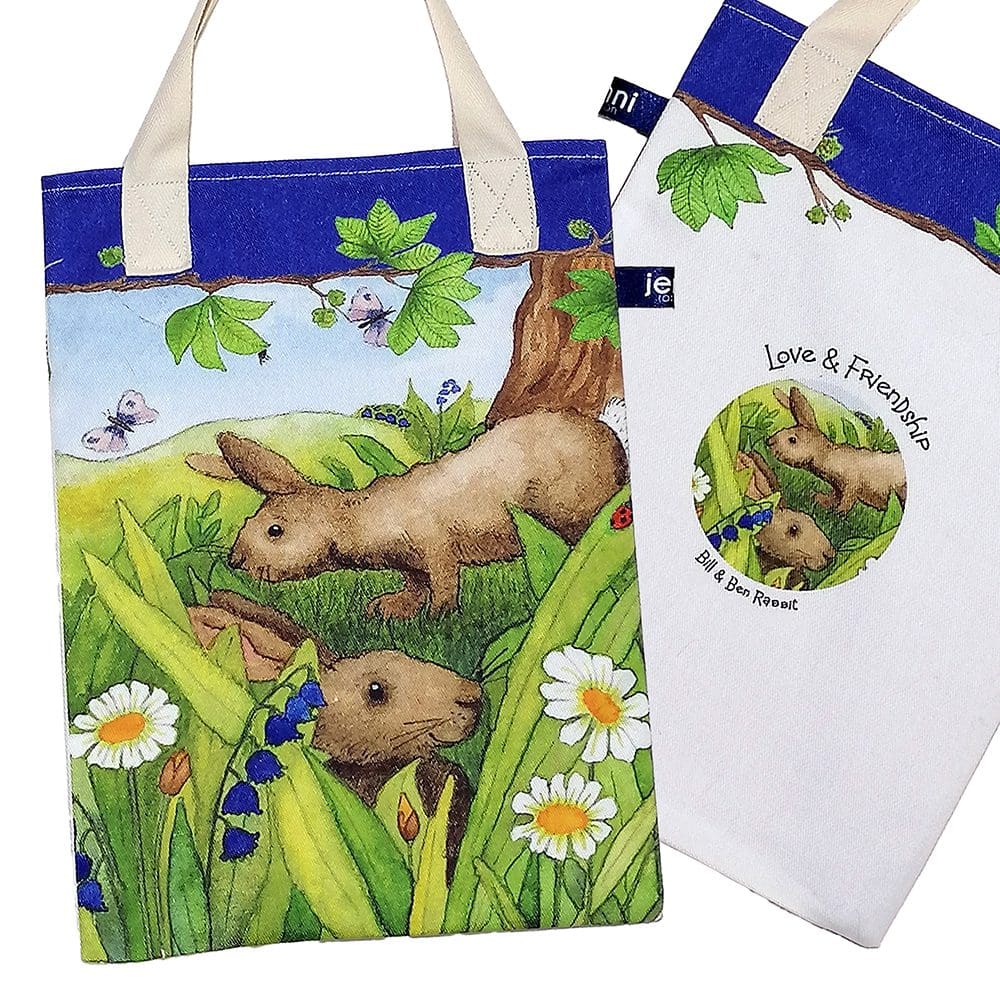 Wildlife bookbag featuring two brown rabbits hiding amongst the grass and daisies on the front and a love and friendship logo on reverse. Blue trim on top with chestnut tree branch decoration and pale cream cotton handles