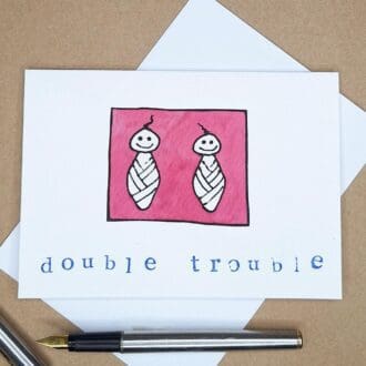 A new baby card for Twins featuring two swaddled cartoon babies and the words 'Double Trouble'.