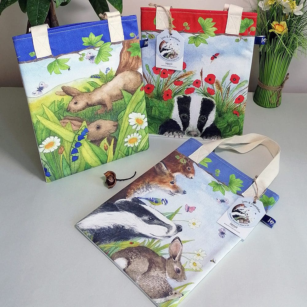 Three book bags from the Wildlife range featuring illustrations of wildlife: rabbits, badgers, hedgehogs and rabbits