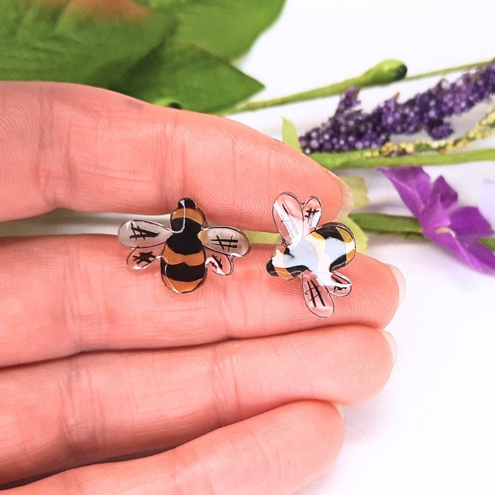 Cute bee stud earrings. Colourful resin bees with a sterling silver stud fitting.
