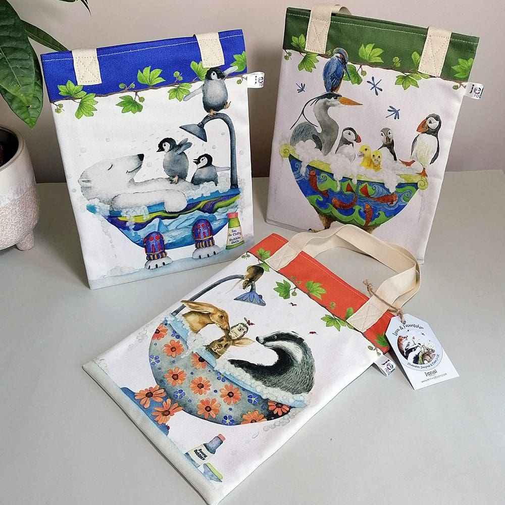 Three of the TubTime range of book bags including the bird bath, hare and badger in the bath and the polar bear and penguins in the bath.