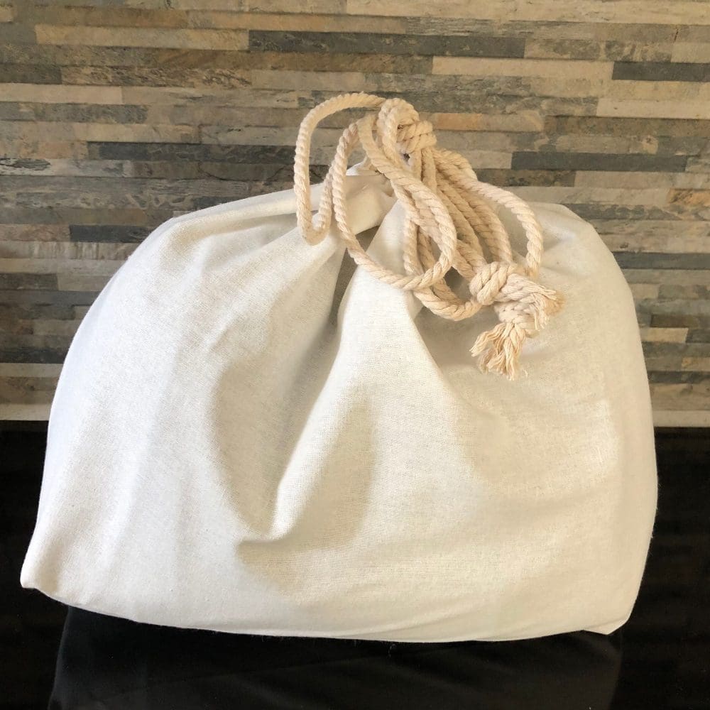 Large cream dust-bag closed with cotton drawstring