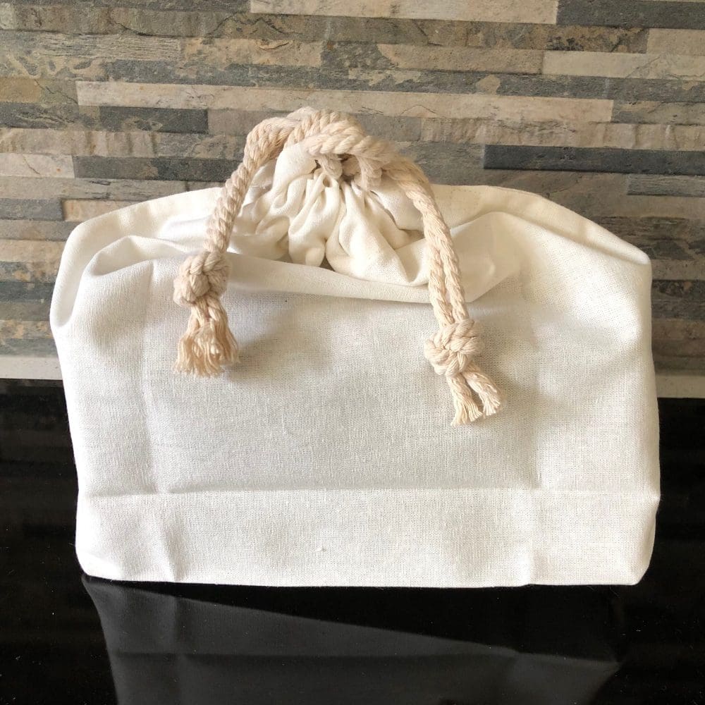 Small cream dust-bag closed with cotton drawstring