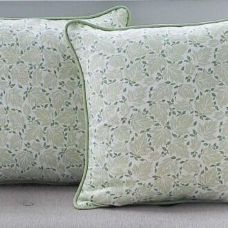 Two cushion covers made from a stylised leaf blockprint in two tone green and ivory.