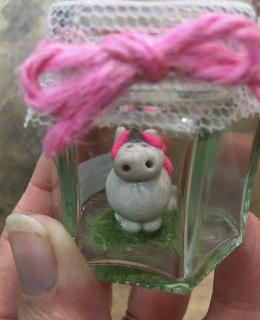 unicorn miniature clay figure in a jar