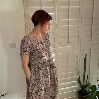 Leopard print dress featuring short sleeves, scoop back and pockets.