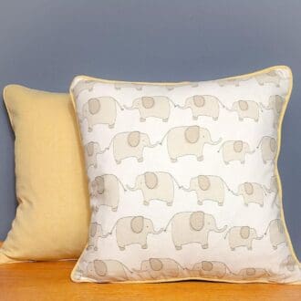 Large nursery cushions featuring elephants against a blue background.