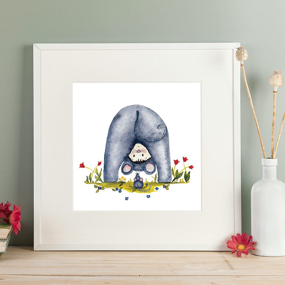 Print of a a young child dressed as his mouse friend, sat amongst the flowers. Giclee print with a white mount. Shown in a readily available standard size square white frame