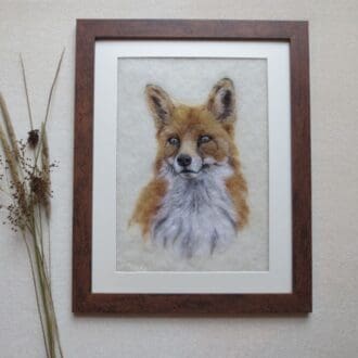 A handmade needle felted wool picture of a fox in a dark wood effect frame.