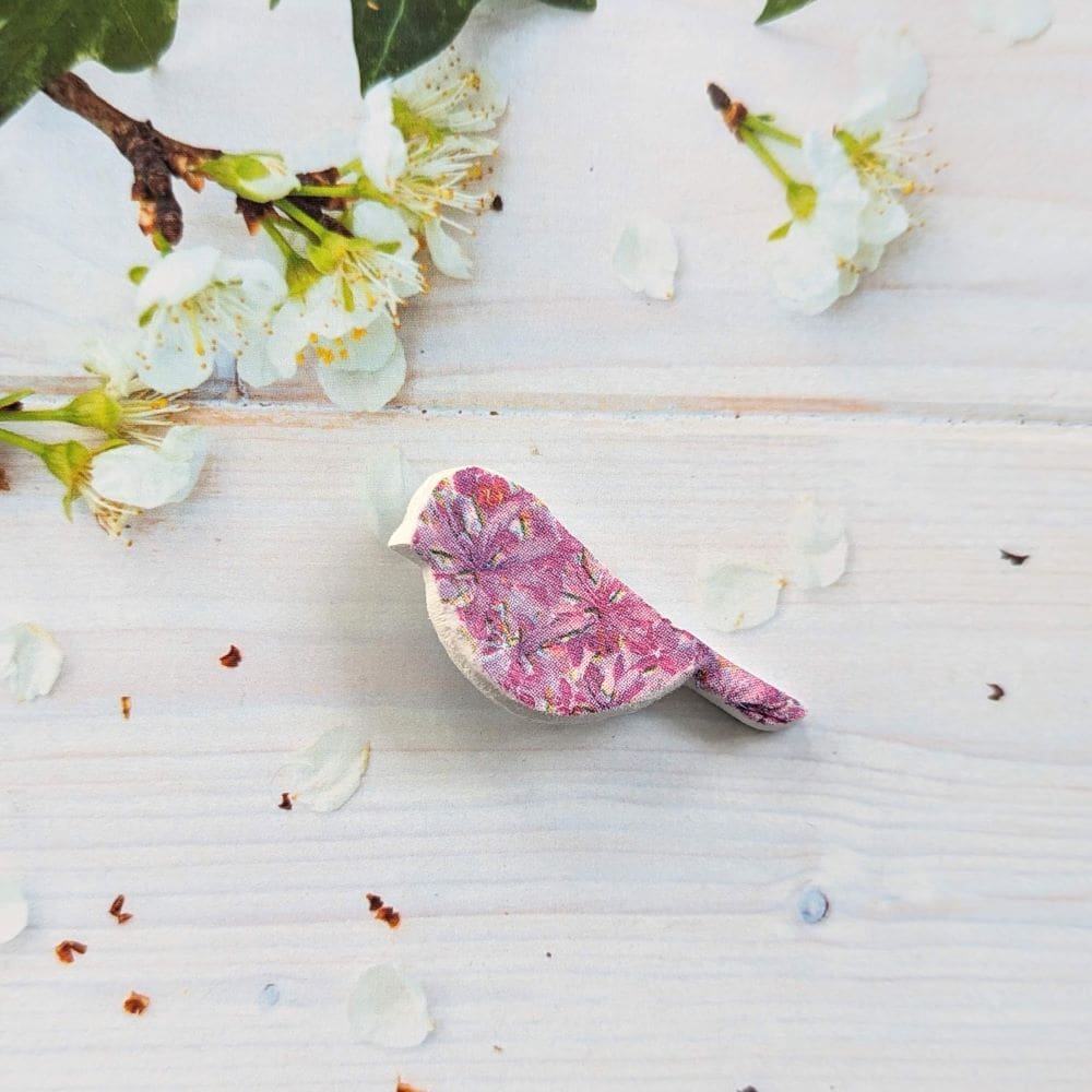 Small clay bird brooch decoupaged with a pink flower design