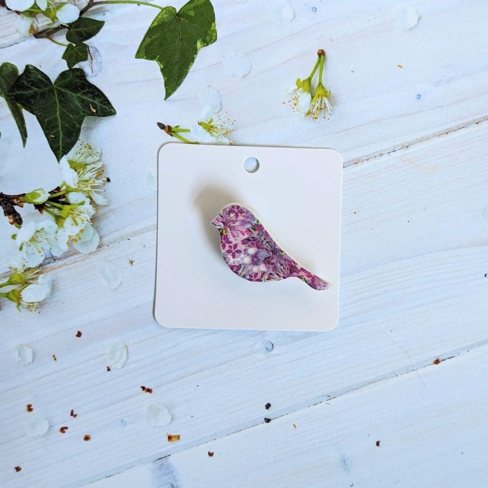 Small clay bird brooch decoupaged with a pink flower design