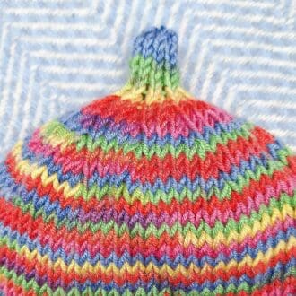 Bright hand knitted pixie hat for 6-18mths