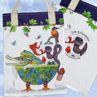 A Croc and frogs bookbag. On the front featuring a crocodile, snake, frogs, fish and a Kingfisher bird sharing a bubble bath. On reverse is the 'Love and Friendship logo with a little close up of Pear fish and Fluff the snake. Purple trim on top edge and pale cream cotton handles.