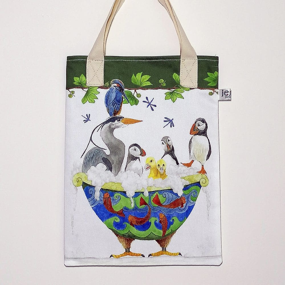 Bird bath bookbag. On the front featuring an unusual mix of birds sharing a bubble bath. On reverse is the 'Love and Friendship logo with a little close up of Bob and Alf puffin and the McPuddle duckling Twins. Dark green trim on top edge and pale cream cotton handles.