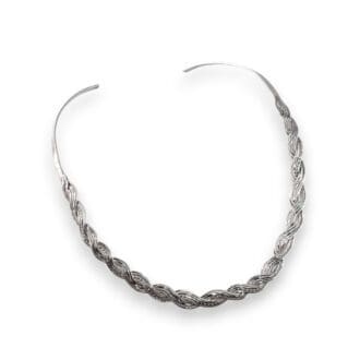 Sterling silver torque necklace with a woven design lying on a white background