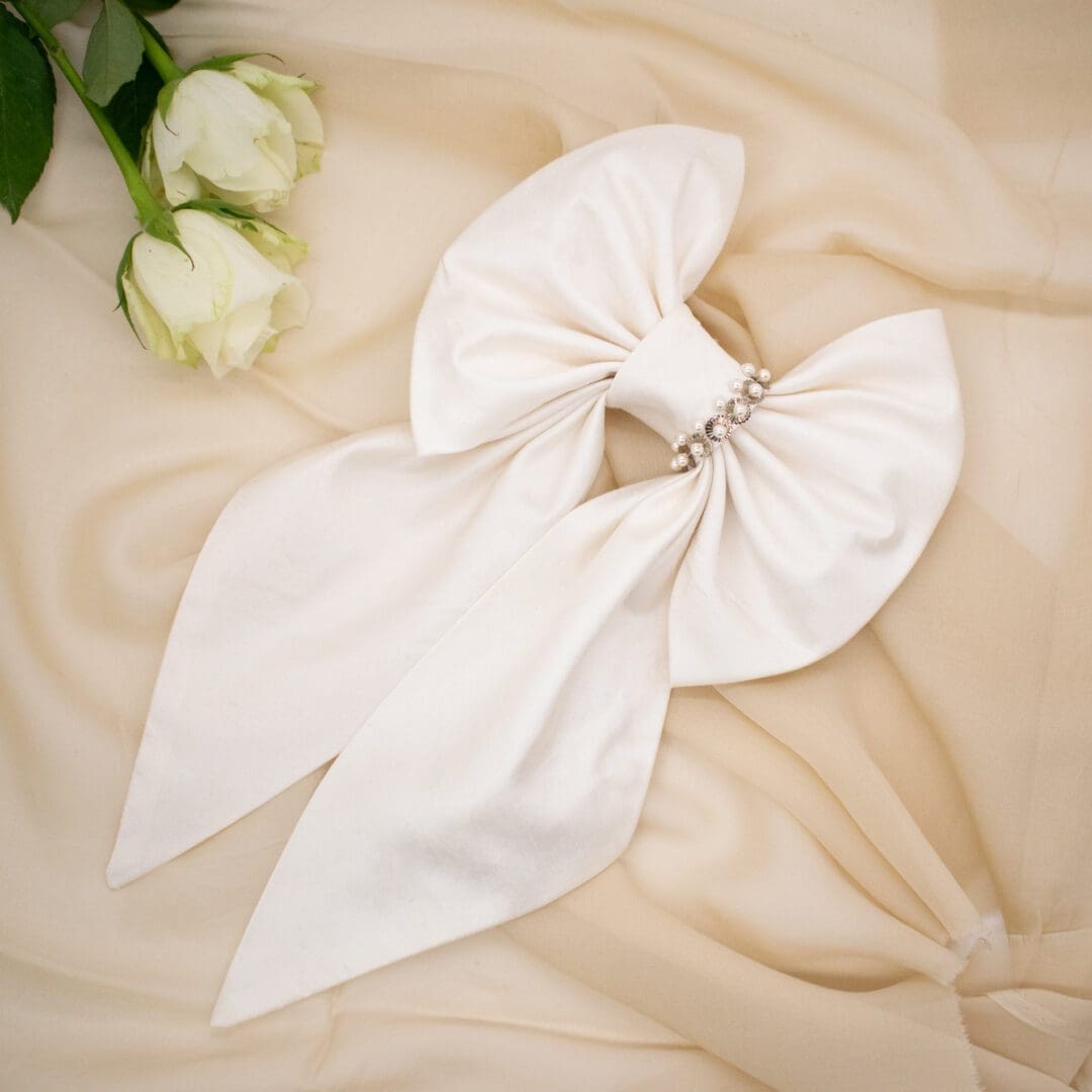large silk bow hair clip in ivory tone with pearl and sequin detailing