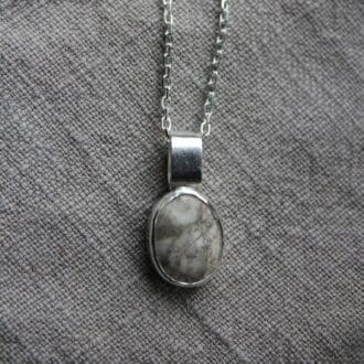 beautiful crazed pebble encased in a silver bezel with a chunky oval bail