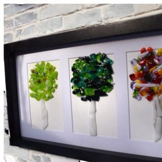 framed picture with fused glass trees depicting the changing seasons