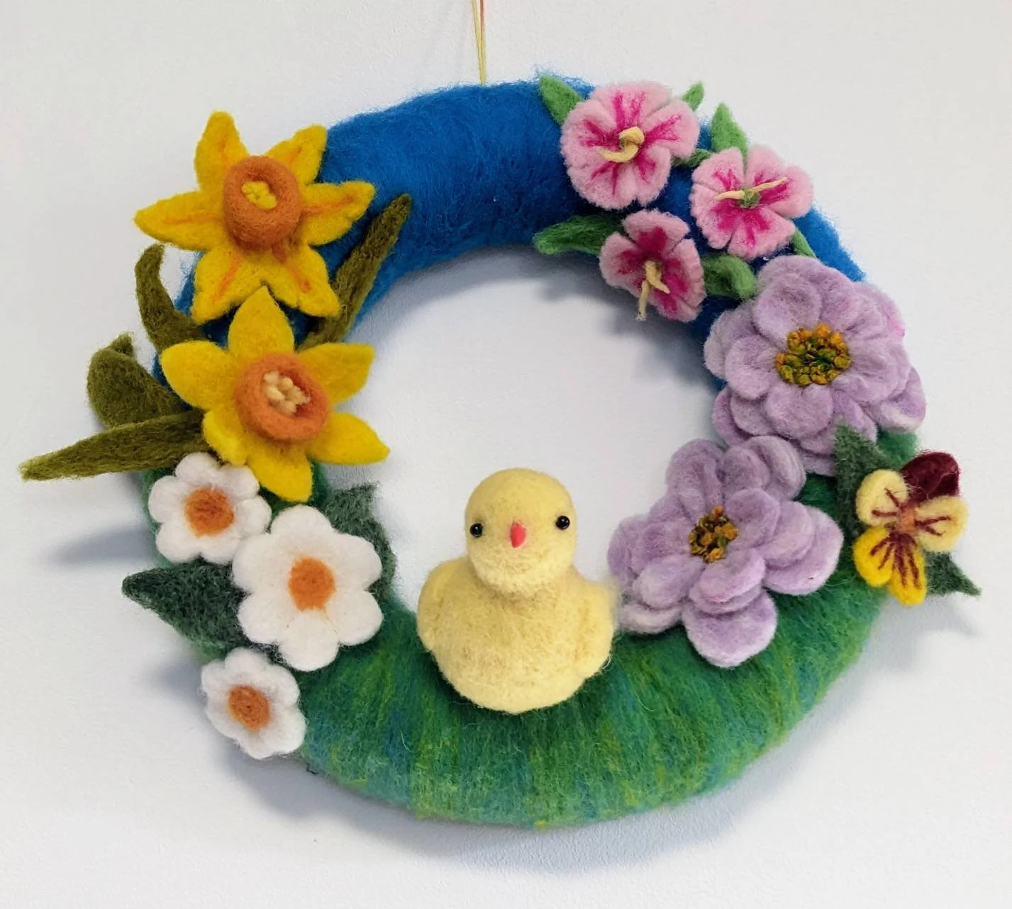 colourful easter wreath with chicks and flowers