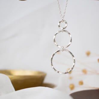 silver pendant featuring three rings of increasing size