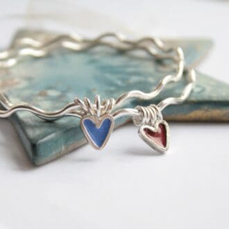 Sterling silver wavy bangle with an enamel heart charm