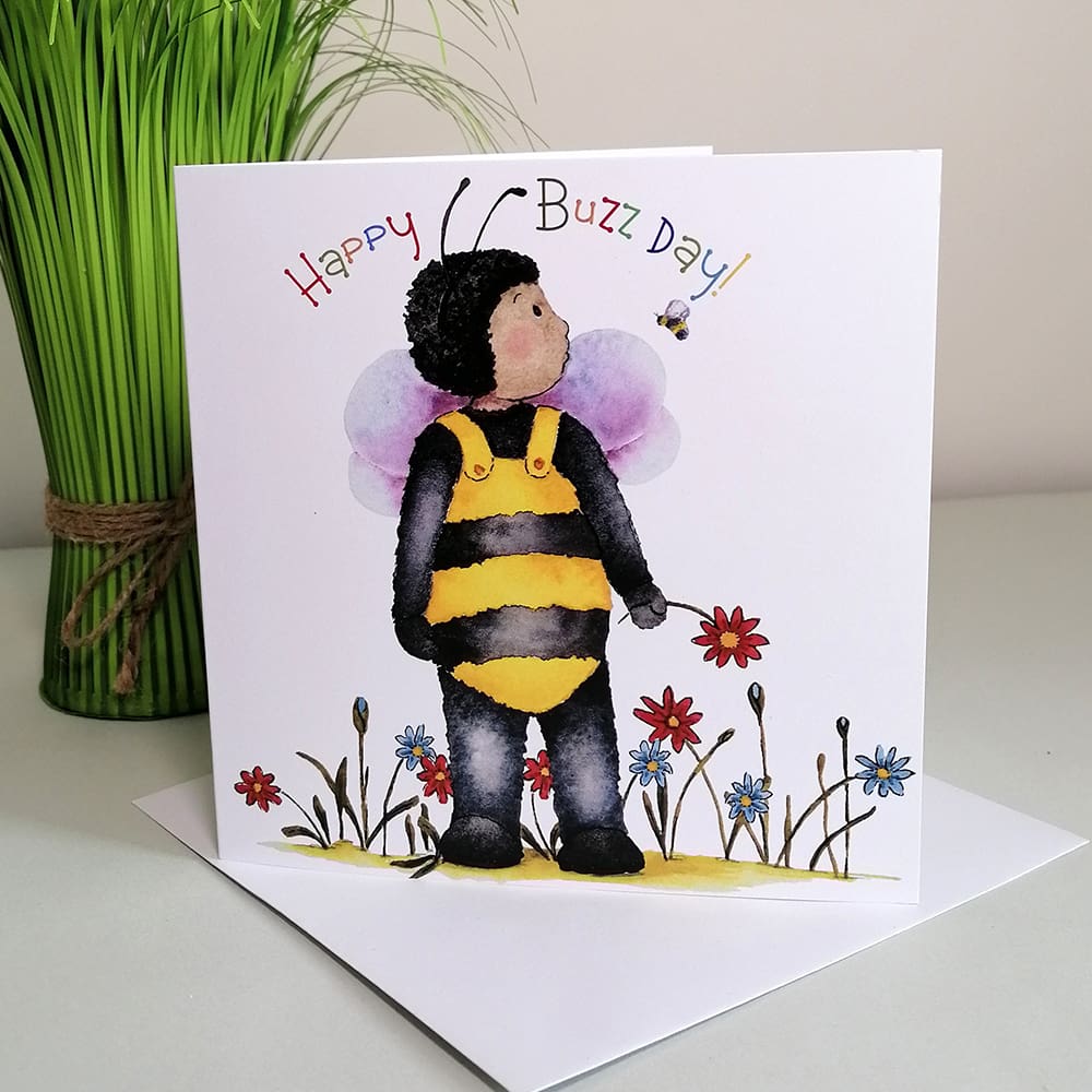 Square, quirky greetings card for kids featuring Gabriel in his fluffy yellow and black bee costume chatting to Busby bee in the garden.