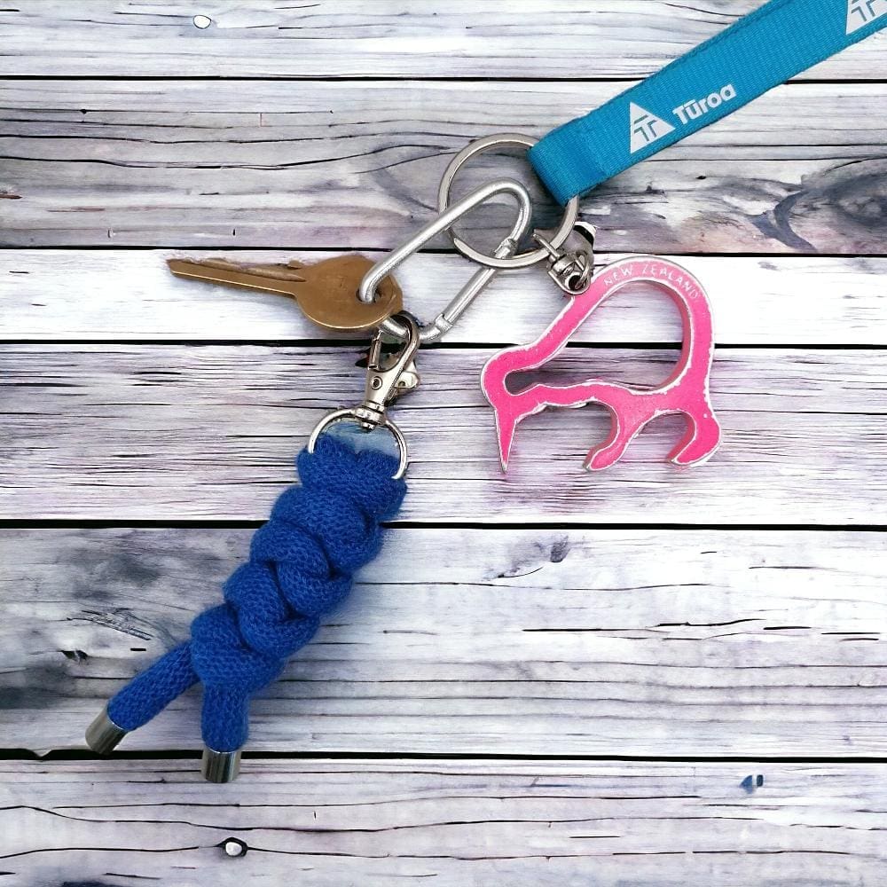 Chunky blue keyring made from recycled knotted cord shown attahced to a bunch of keys nad displayed on a lightwooden background