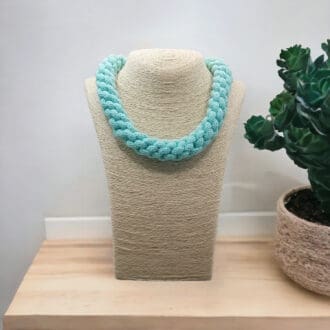 Chunky Aqua Blue Rope Necklace displayed on a stand with a white background