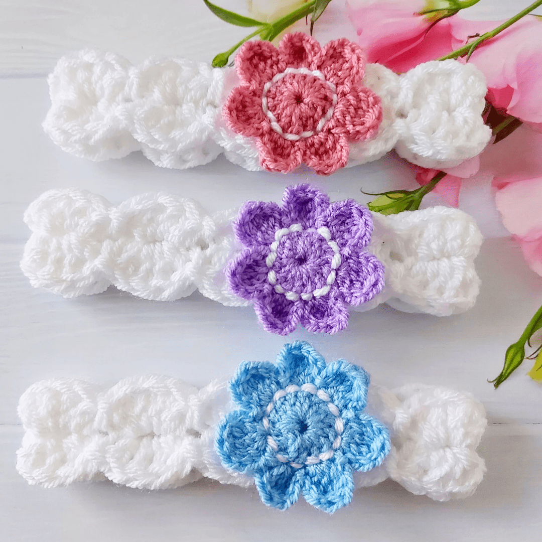 white crochet headbands with a coloured flower attached to the front, they come in sizes newborn up to adult and there is a section of colours to choose form