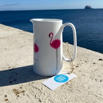 White ceramic jug with pink flamingos handpainted with sea in background