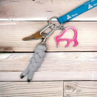 Chunky grey keyring made from knotted recycled cotton cord displayed on a bunch of keys on a light wooden background.