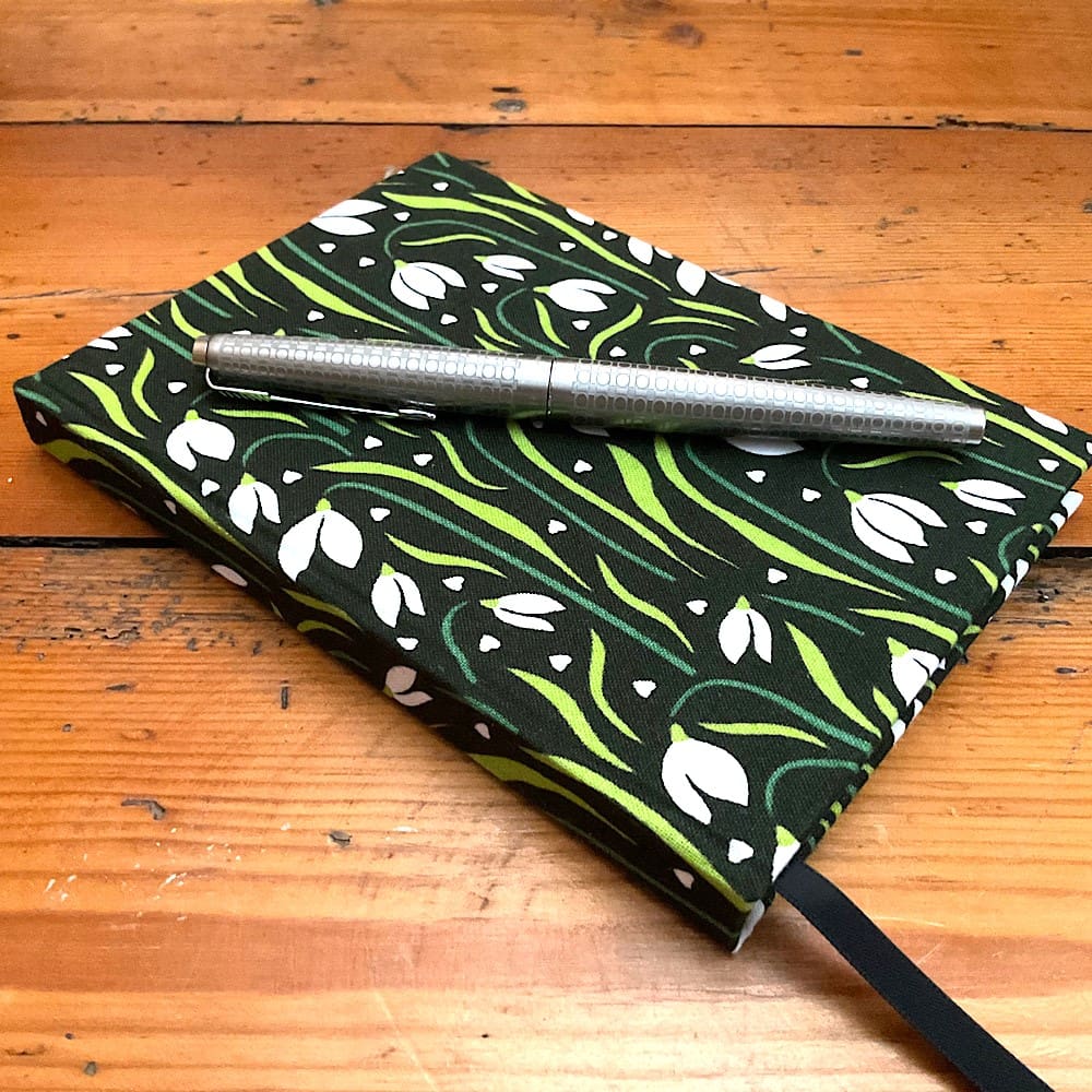 A6 handmade notebook covered in a Snowdrop print fabric filled with plain paper