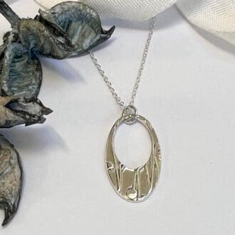 Handmade silver oval necklace with pattern